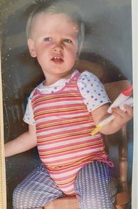 Me, almost 2 years old, at my art table with markers in hand
