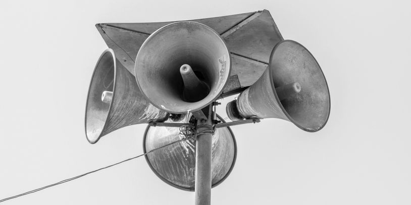 Four loud speakers in black and white.