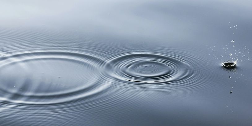 The ripples on water from drops of rain.