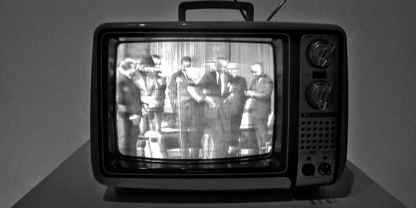 An old-fashioned television set with black and white picture.