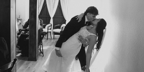 Bride and groom share a romantic kiss during their wedding.
