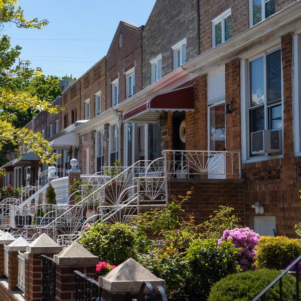 A row of classic brownstone townhouses with tree-lined streets.