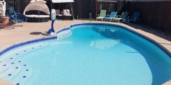 Outdoor swimming pool with lounge chairs.