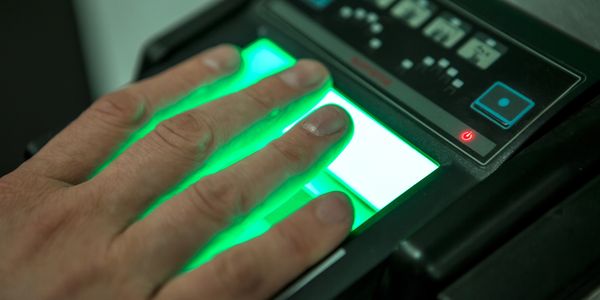 Fingers on a Live Scan fingerprint machine