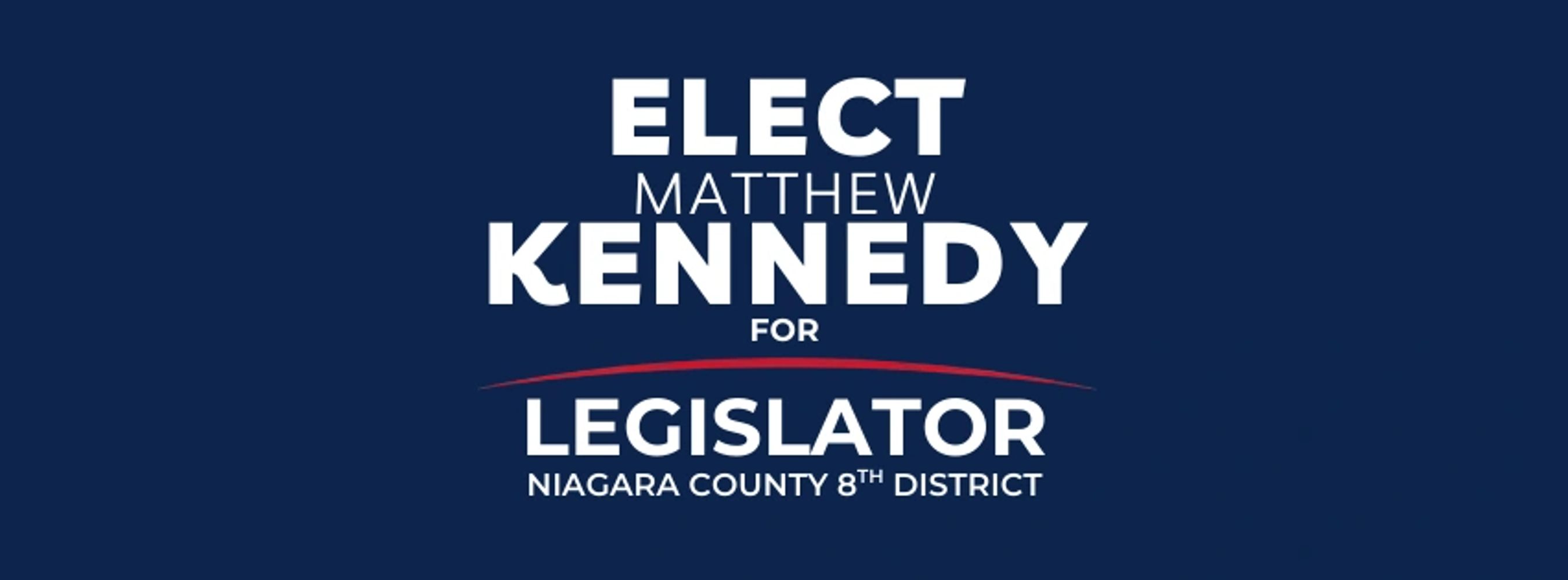 City skyline at dusk with illuminated buildings and autumn trees.