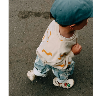 Smiling woman engaging in a lively outdoor group discussion.