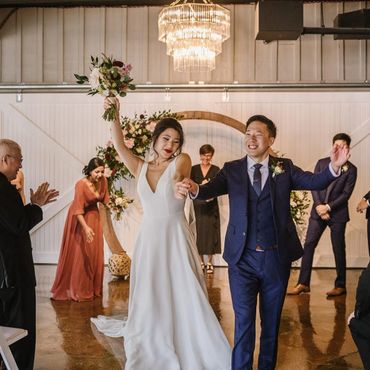 Bride & groom dancing back up the aisle as their Ontario Wedding Officiant looks on.
