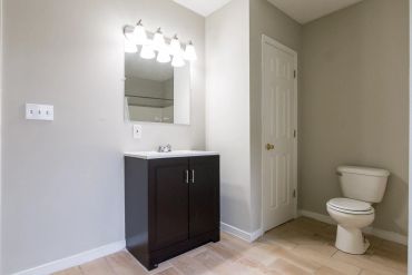 Minimalist bathroom with vanity and toilet.