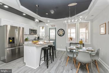 Modern kitchen with island and dining area.