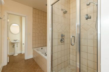 Bathroom with a shower, bathtub, and pedestal sink.