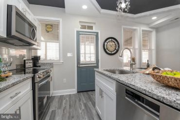 Modern kitchen with gray and white tones.