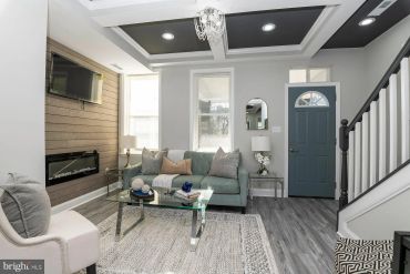 Cozy living room with modern decor and fireplace.