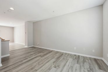 Empty room with gray flooring and white walls.