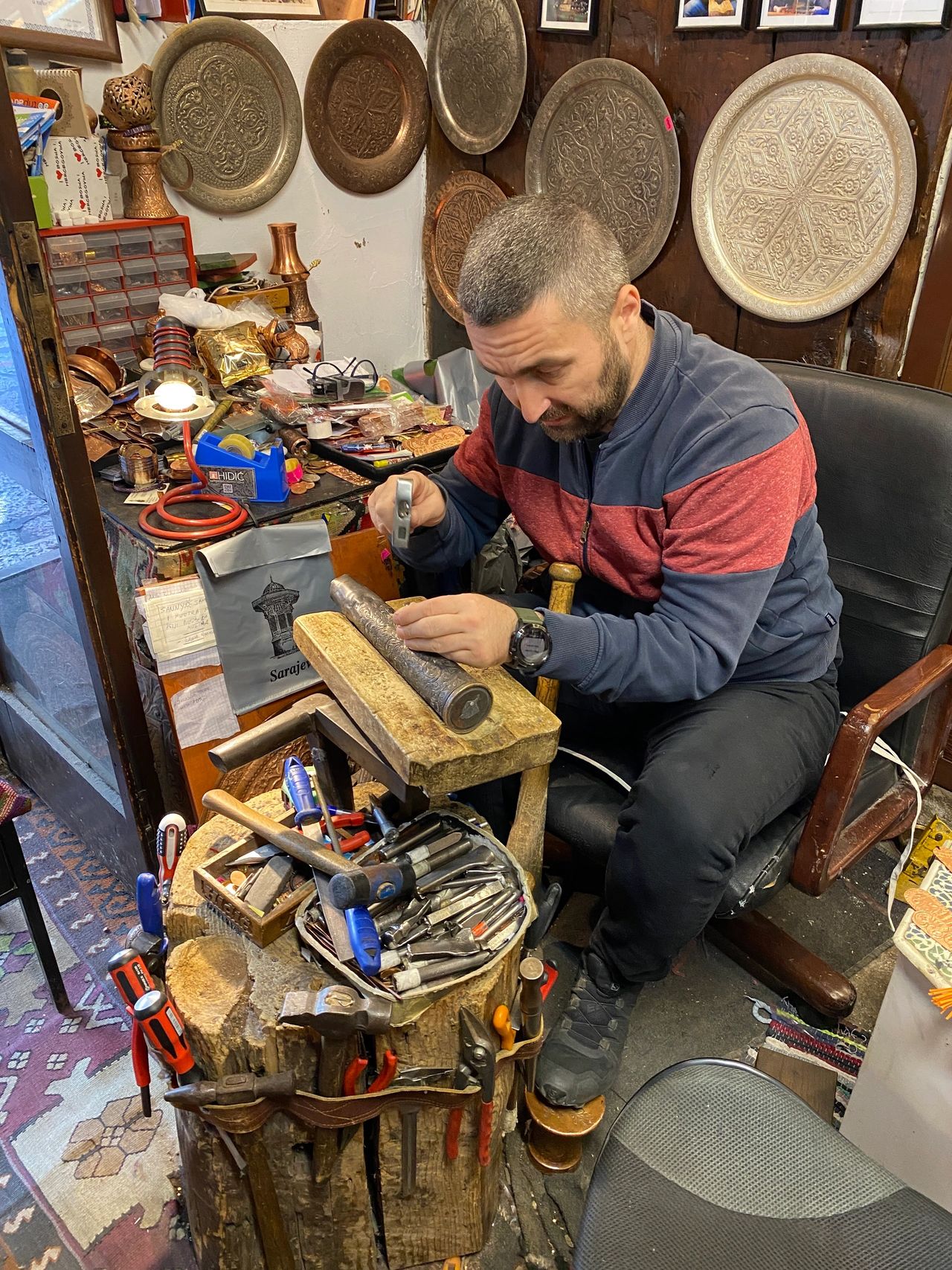 Shopowner creating artwork from artillery shell
