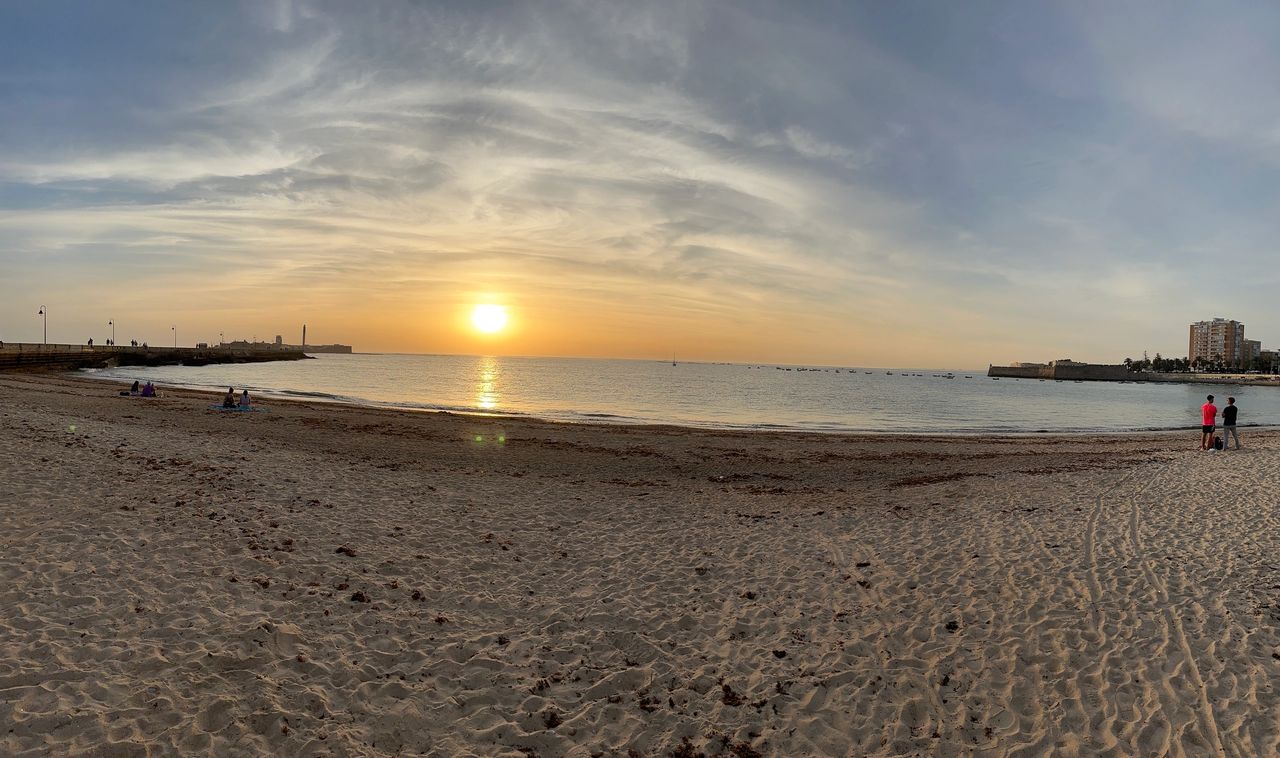 Sunset on the beach in Cadiz with Castillo de San Sebastian in the background
