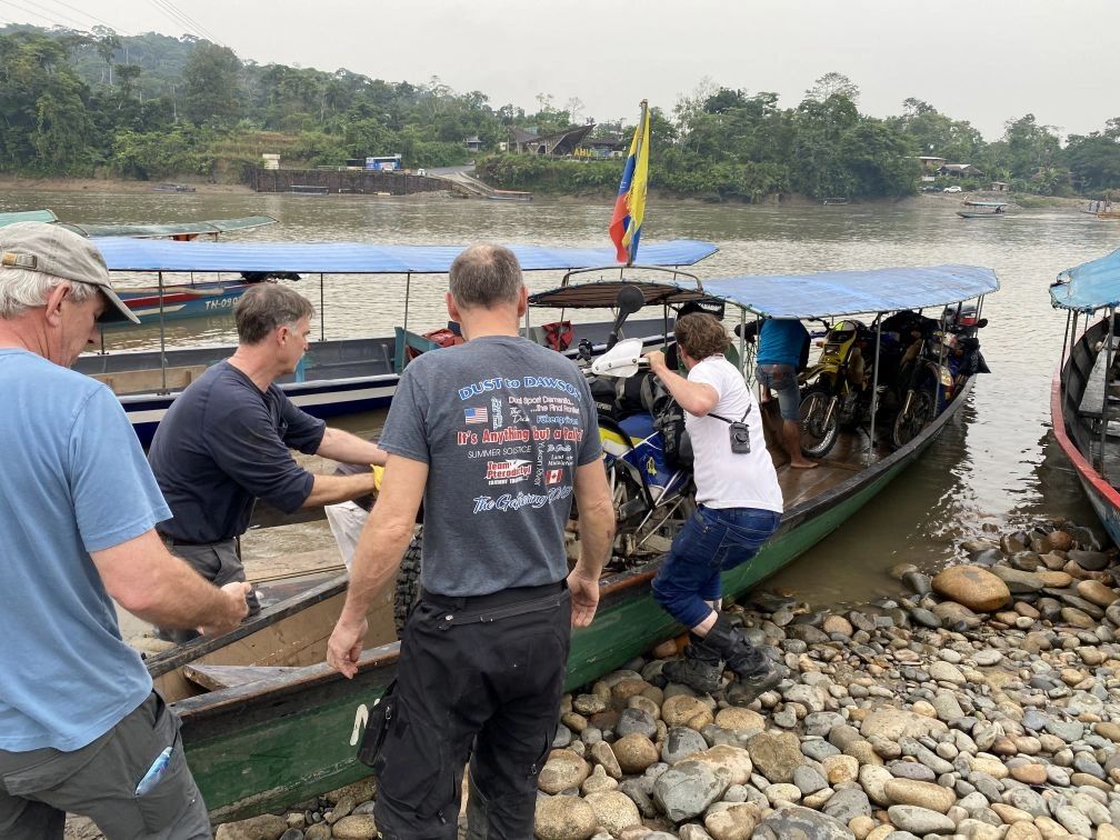Loading our bikes into canoes
