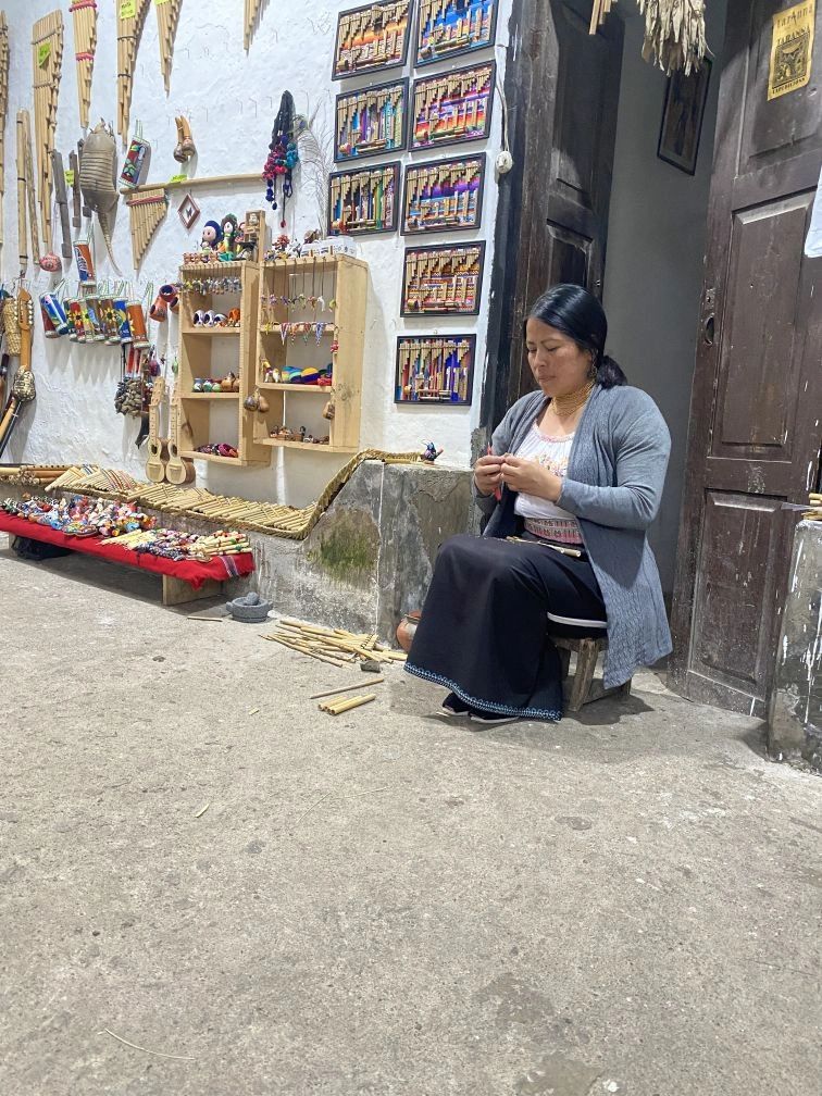 This woman was hand making traditional instruments and played some for us