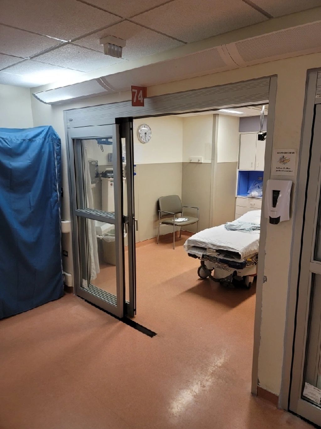 Hospital room with a bed and chair.