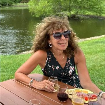 Woman sitting at a picnic table outside