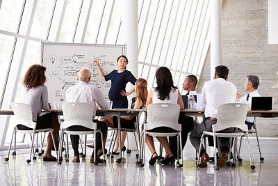 A businesswoman presenting a strategy to colleagues in a modern office.