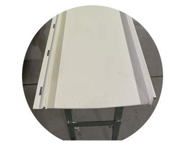 White metal roofing panel on a stand in a workshop.