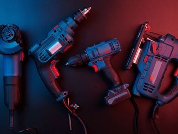 power tools isolated on a black background, drill, puncher, electric saw, jigsaw, circular saw