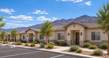 Row of single-story houses in a desert landscape.