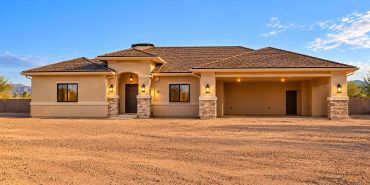 A modern single-story house with a tiled roof and spacious driveway.