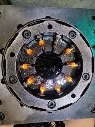 Close-up of a mechanical component with illuminated orange tips.