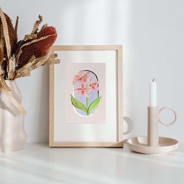 watercolor painting of red and white lily on blue oval