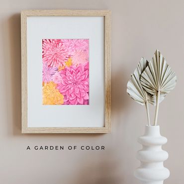 Layered watercolor garden collage of pink, yellow, purple, and orange dahlias.