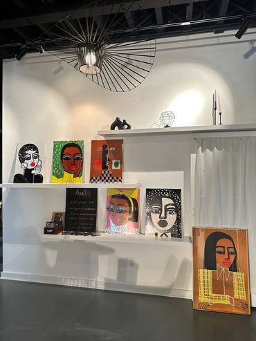 Art and prints by Maridel Lane & Natalie Osborne on built-in shelves at the Fulton West