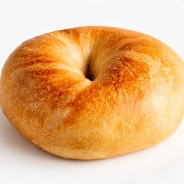 Golden brown bagel on a white background.