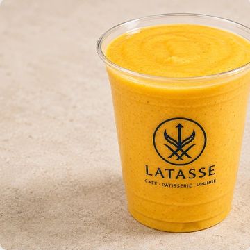 Orange smoothie in a clear cup from Latasse café.