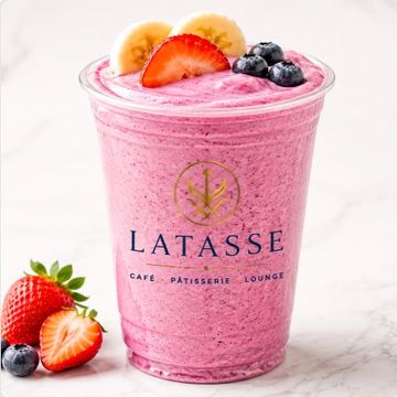 Berry smoothie with fresh fruit toppings in a LATASSE cup.