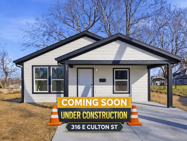 New house under construction with a 'Coming Soon' sign in front.
