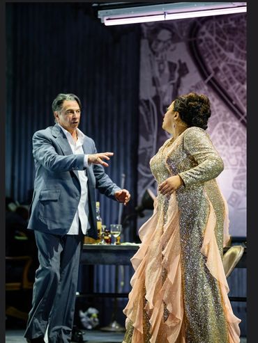 Two actors engaged in an intense theatrical scene on stage.