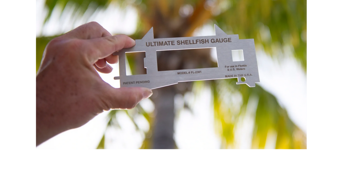 The Ultimate Shellfish Gauge in front of a palm tree.