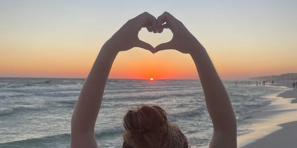 Heart hands in sunset