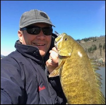 zip decker with a big smallmouth bass from the river