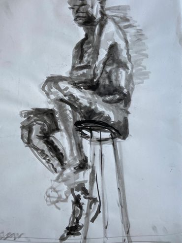 Figure drawing of a man on a chair.