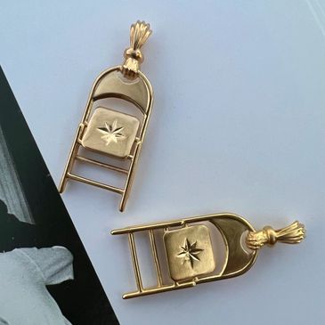Sweet Chairiot folding chair jewelry in gold inspired by Montgomery brawl and Shirley Chisholm