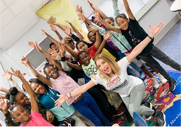 Teacher and student having fun together in the classroom