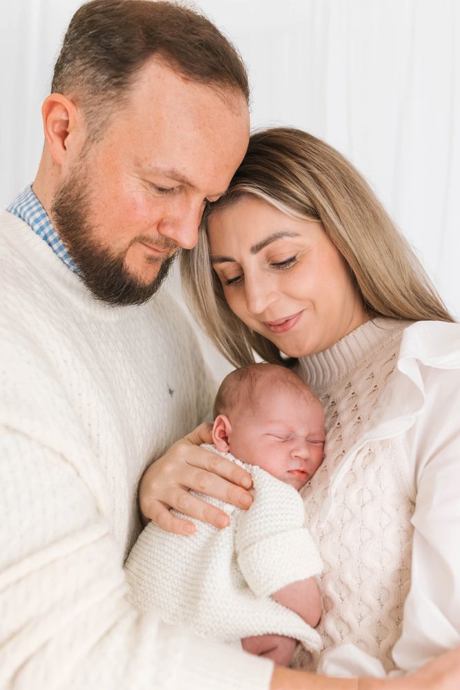Newborn baby held in parent hands