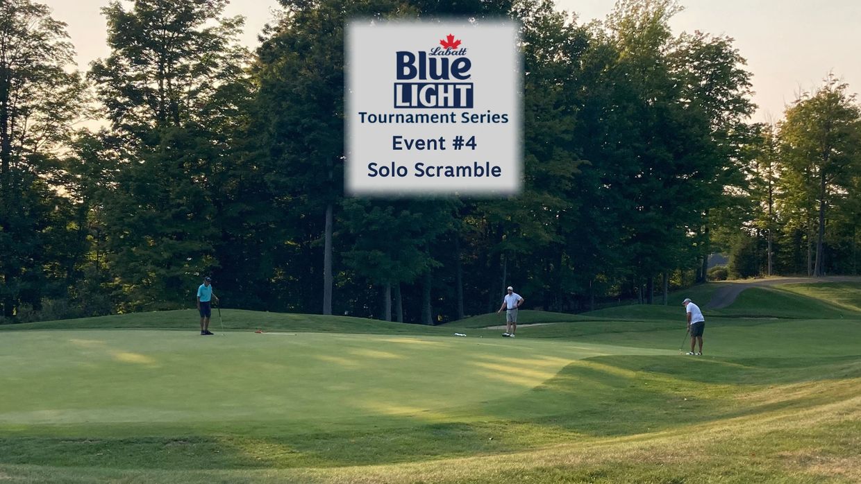 Golfers playing in the Labatt Blue Light Solo Scramble tournament on a sunny course.