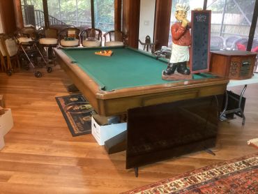 Pool table and a chef statue with a chalkboard.
