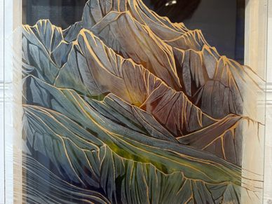 Artistic painting of rugged mountain peaks with detailed ridges and shadows.