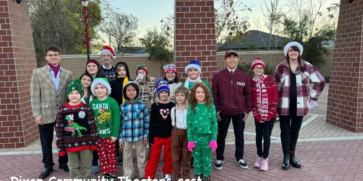 Dixon Community Theater cast posing outdoors for Christmas event.