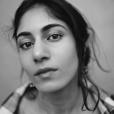 Close-up portrait of a woman with natural makeup and loose hair.