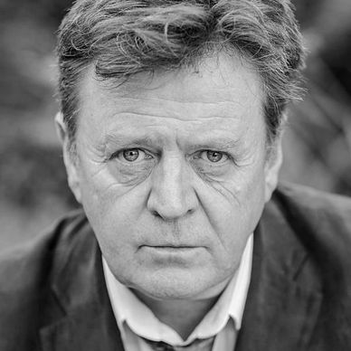 Portrait of a serious middle-aged man with blue eyes.